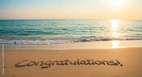 Congratulations Message Written in Sand at Beach with Sunset Light