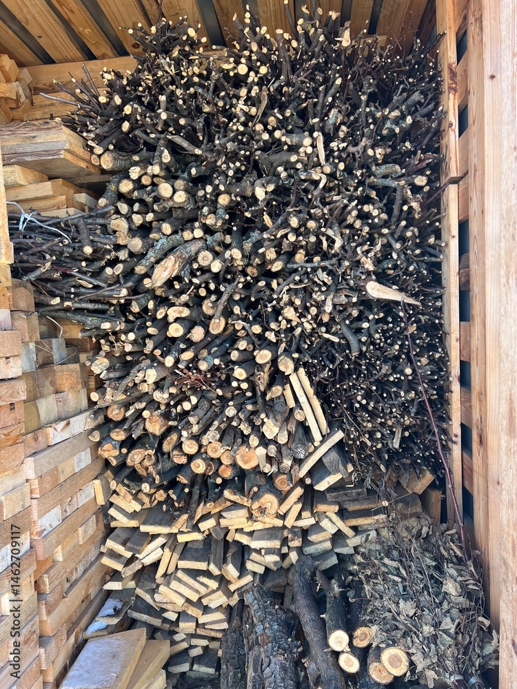 Firewood in the woodshed, preparation for the heating season in the village. Warm, brown colors, rustic style
