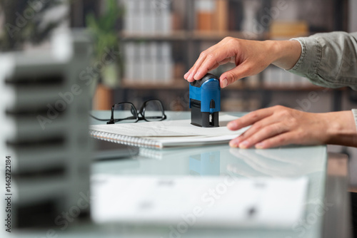 Female hand puts a stamp on a real estate deal