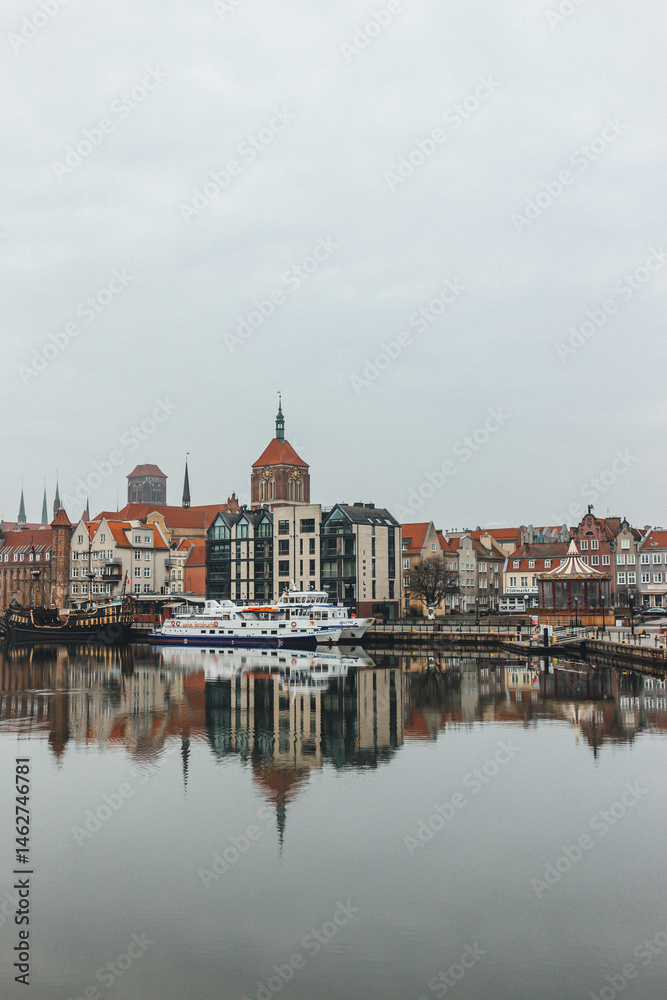Obraz premium view of the old town of gdansk church towers and beautiful old north baltic colorful houses polish and water reflection