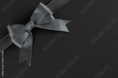 Black  ribbon and bow on black background