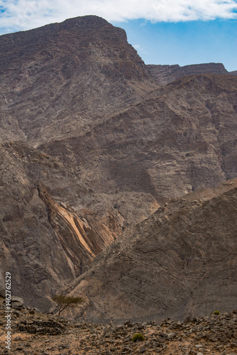 Obraz na płótnie Oman, 03-06-2025: canyon and view of the winding road to Jebel Al Harim (Jabal Al Harim), the highest mountain (2,087 metres), located in the Hajar Mountains range, of the Musandam Peninsula w salonie