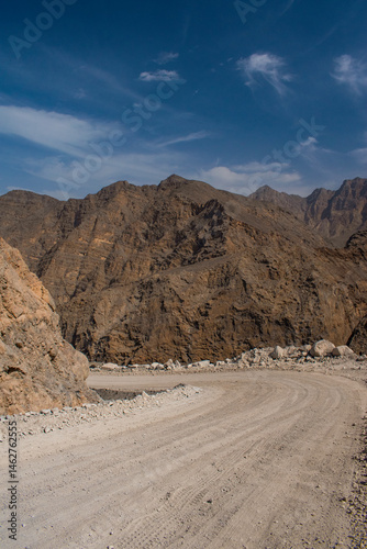 Obraz na płótnie Oman, 03-06-2025: canyon and view of the winding road to Jebel Al Harim (Jabal Al Harim), the highest mountain (2,087 metres), located in the Hajar Mountains range, of the Musandam Peninsula w salonie