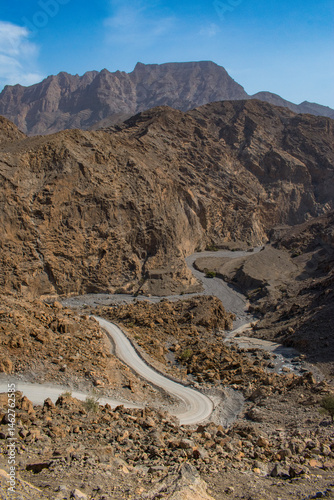 Obraz na płótnie Oman, 03-06-2025: canyon and view of the winding road to Jebel Al Harim (Jabal Al Harim), the highest mountain (2,087 metres), located in the Hajar Mountains range, of the Musandam Peninsula w salonie