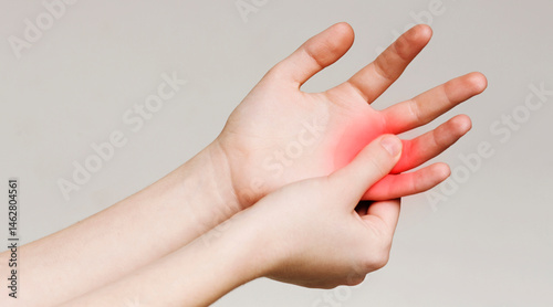 Pain and numbness in fingertips and palms. Woman massaging her sore hand, panorama