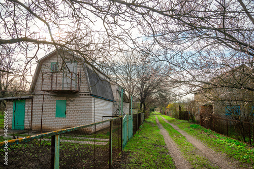 Old abandoned village in the forest at the spring time . Old houses , woodlands and village 