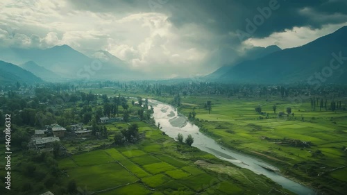 Drone view from Kashmir's disputed border line, barbed wire, military outposts, abandoned buildings, but also lush green rice fields and clear rivers. 