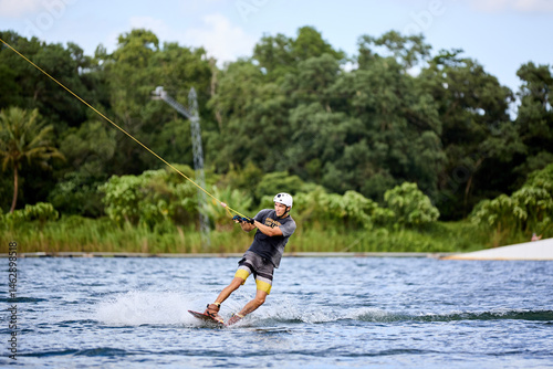 Wakeboarder Riding on Water Holding Tow Rope