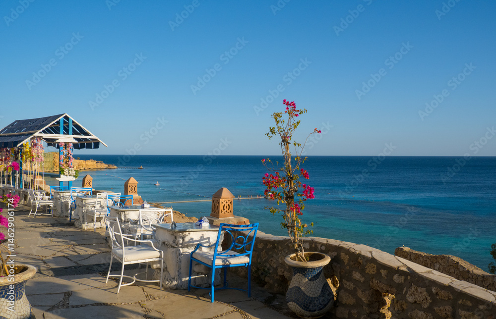 Beautiful white and blue street cafe on the seashore