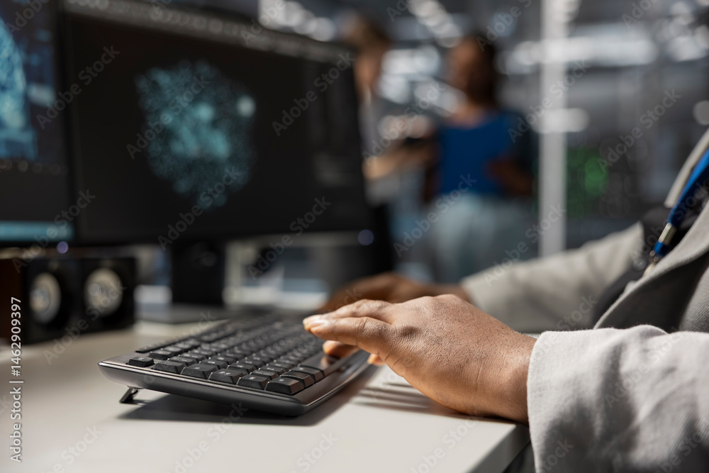 Close up of server hub engineer typing on PC keyboard, looking at data visualization to pinpoint performance issues. Data center worker writing code to reduce hardware failures
