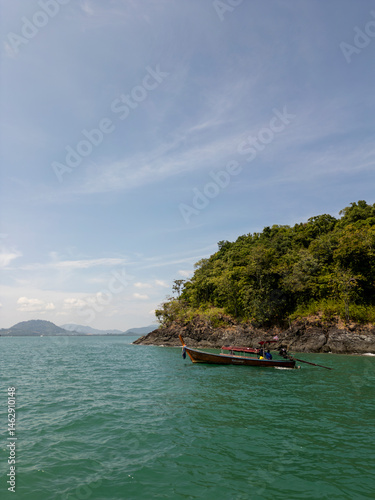 Obraz na płótnie Drone shot of tropical beach and panoramic forest with exotic palm trees and blue sky, coastal scenery featuring tall coconut trees on a sunny shoreline. Tranquil seashore in Thailand, drone shot. w salonie
