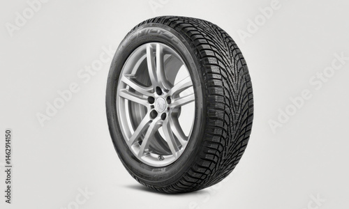 A single car tire on a white surface