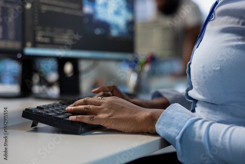 Obraz na płótnie Engineer in data center typing on keyboard, optimizing IT infrastructure using network management skills. Close up of server room employee upgrading equipment, reducing operational costs w salonie