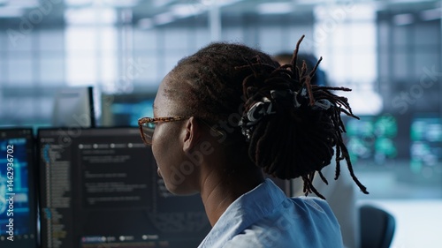 Obraz na płótnie Woman programming in AI data center housing advanced equipment used for machine learning training. African american admin running code to upgrade artificial intelligence tech, camera A close up w salonie
