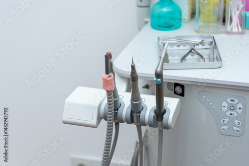 Podiatry tools hanging on a modern medical device in a clinic