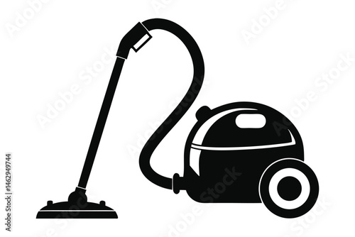Black vintage canister vacuum cleaner has a wheeled base and a long hose