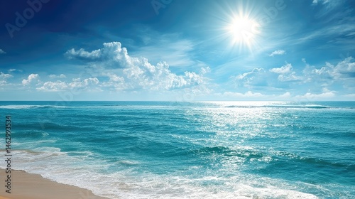 A serene ocean view under a bright sun, showcasing tranquil waves and a clear sky.