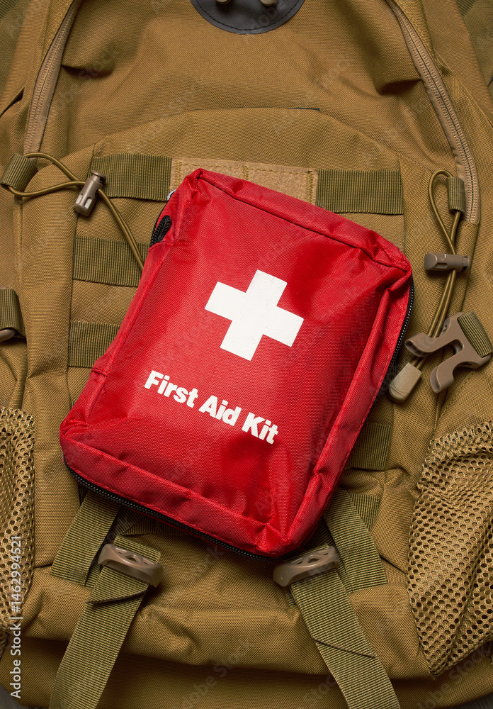 Naklejka premium First Aid Kit on army backpack