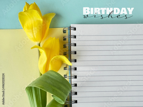 Yellow tulips with a spiral notebook on a pastel background and text 