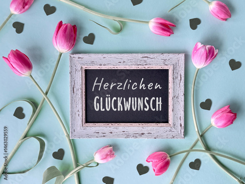 Pink tulips and black hearts around a rustic frame with text 