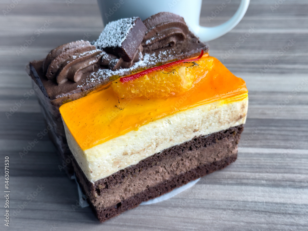 Close up view of rich chocolate and mango pastries plus coffee for morning breakfast