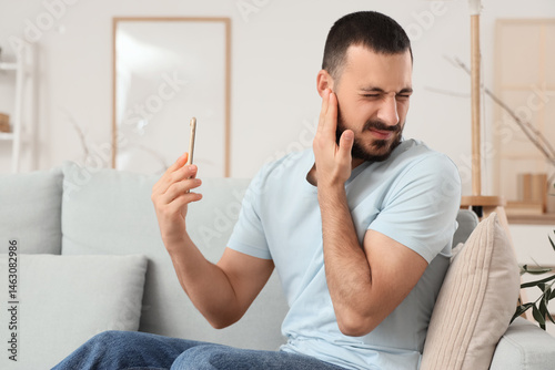 Young man with mobile phone...