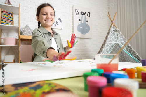 Cute girl painting with her...