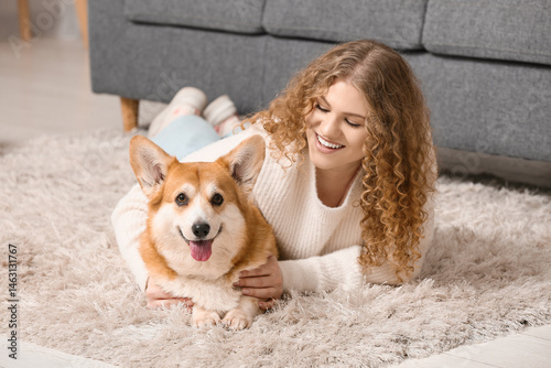 Young woman with cute Corgi...