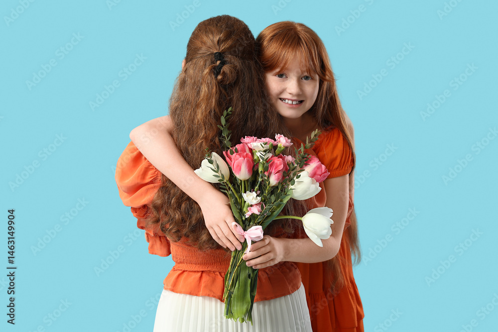 Young woman and her cute daughter with bouquet of beautiful flowers on blue background. Mother's Day celebration Young woman and her cute daughter with bouquet of beautiful flowers on blue background. Mother's Day celebration
