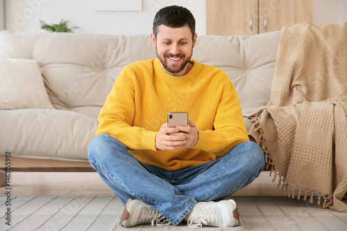 Surprised young man using m...