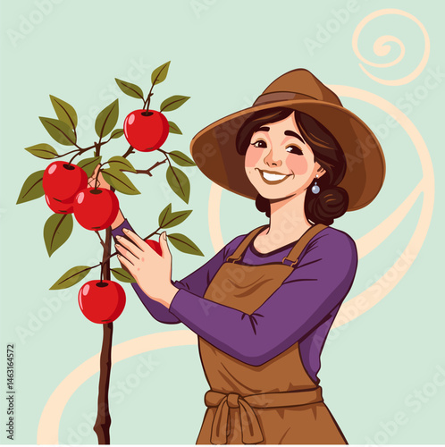 A smiling woman wearing a hat and apron picking red apples from a tree.