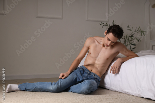 Young man with anorexia sit...