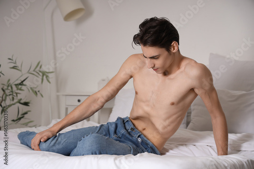 Young man with anorexia sit...