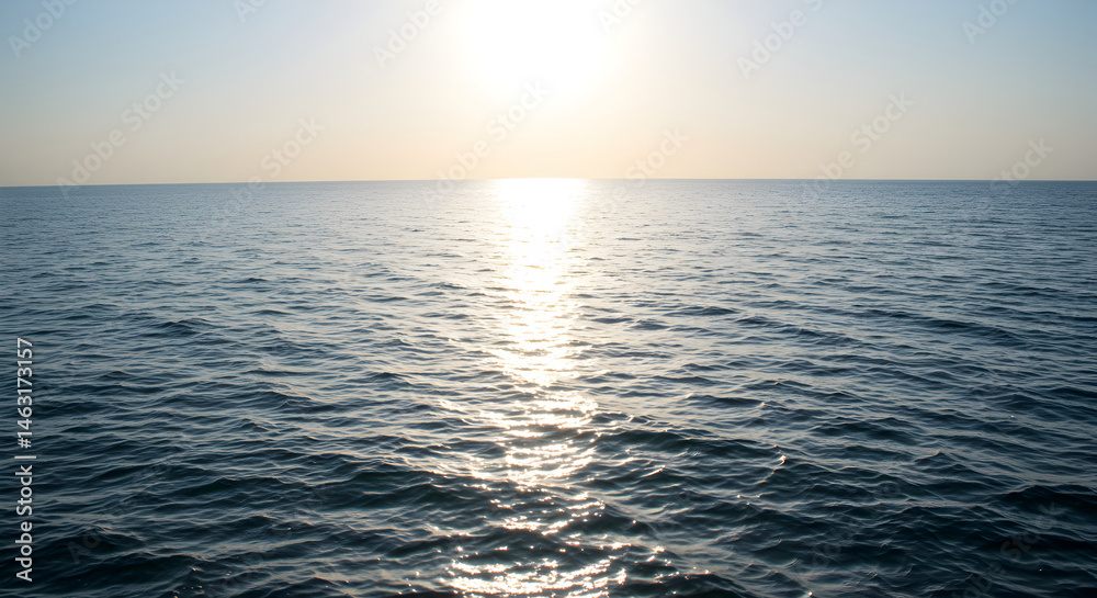 Fototapeta premium Golden Hour Reflections: Serene Ocean View at Sunset Over Calm Waters