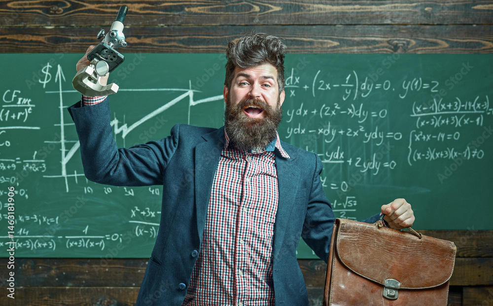 Teacher explains math at blackboard. Professor in classroom with chalkboard. University professor writes math formula. Bearded teacher. Professor teaching lesson in classroom. Professor explains math.