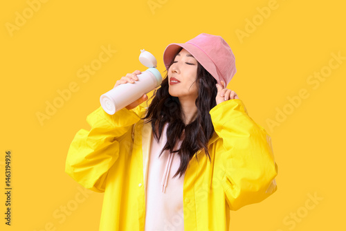 Young Asian woman in rainco...