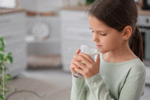 Cute girl drinking water in...