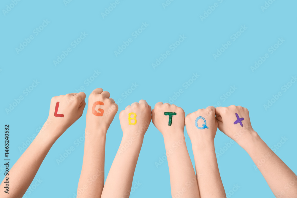 Naklejka premium Female hands with abbreviation LGBTQ+ on blue background