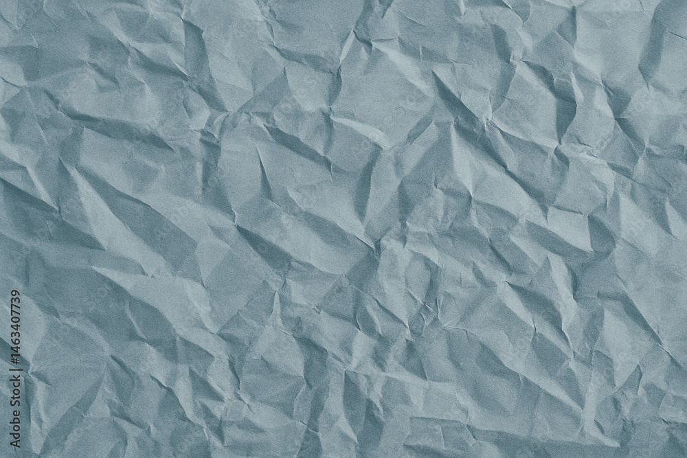Obraz premium Crumpled Faded Blue Paper Texture Background – Realistic Wrinkled Soft Blue Surface for Collage, Scrapbook, or Design Use