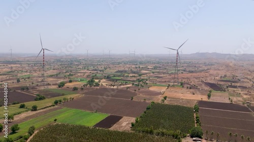 Beautiful aerial view of wind farm and agriculture field in summer located in Nandurbar District, Maharashtra State, India. 