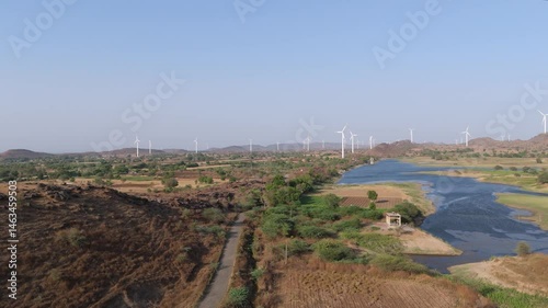 Beautiful aerial view of wind farm and agriculture field in summer located in Nandurbar District, Maharashtra State, India. 