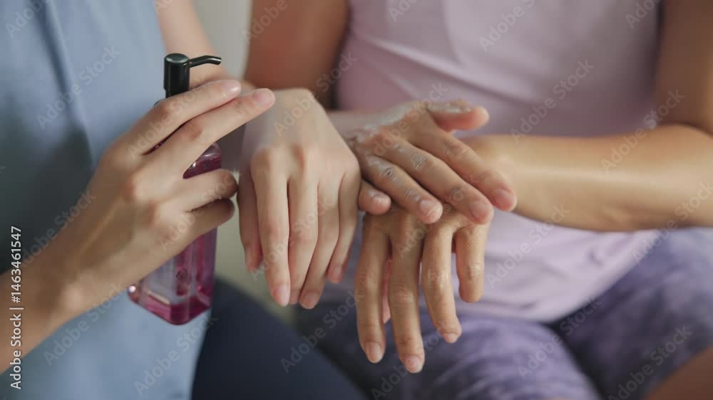 Asia young adult aged mom people middle age happy old woman smile apply cream body oil herb vitamin c e reduce dry arm elbow hand skin health care sit at home sofa elder aging beauty asian female mum.