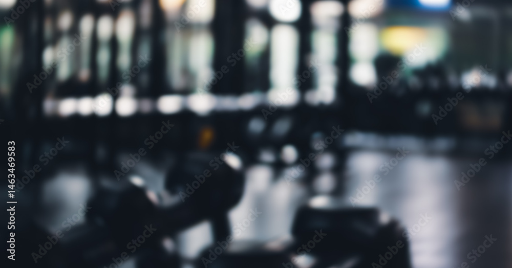 Fototapeta premium Out of focus gym interior with exercise equipment and mirrored wall.