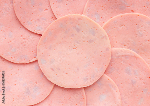 Sliced ham ​​bologna sausage stacked in a circle. Top view photo