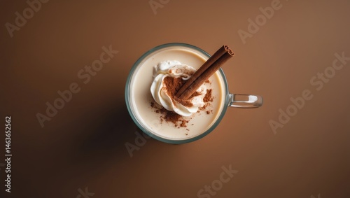 Healthy traditional arabic sahlab beverage with cream, nutrious ingredients, and cinnamon in a glass, top view photo