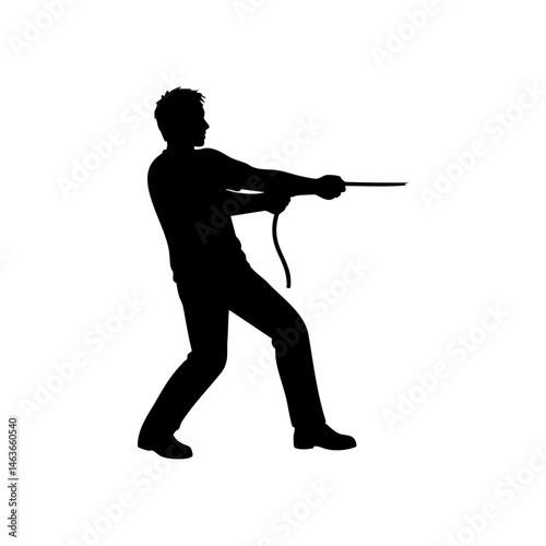Silhouette of man pulling rope with effort