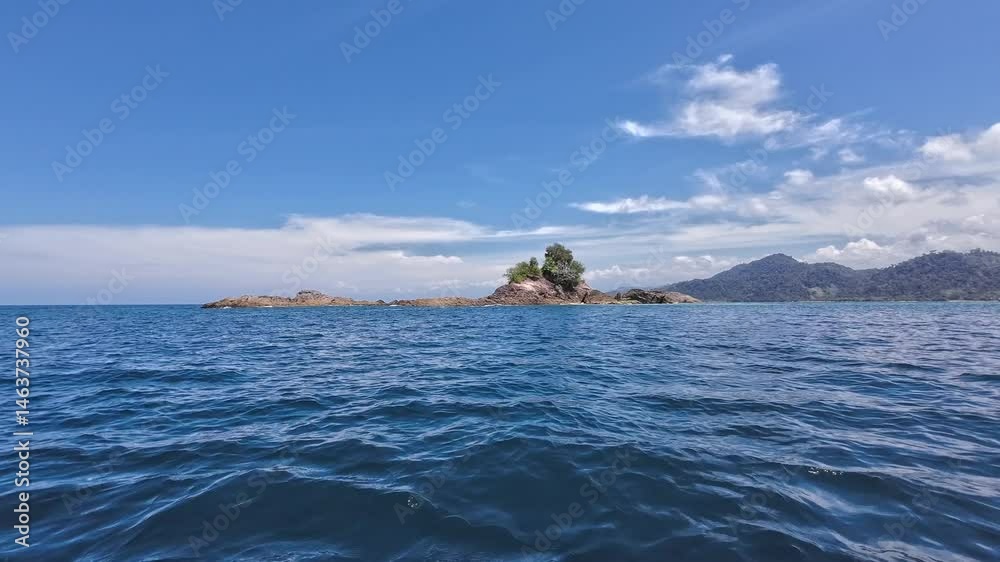 Moving sideward scene. Beautiful landscape, sea and islands. The sky is blue. Mandeh, Padang, Indonesia
