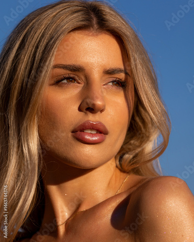 Close-up portrait of a beautiful woman with sun-kissed makeup in golden tones, glowing skin, and soft summer vibes. Warm sunlight highlights her natural beauty, perfect for beauty, fashion, and lifest