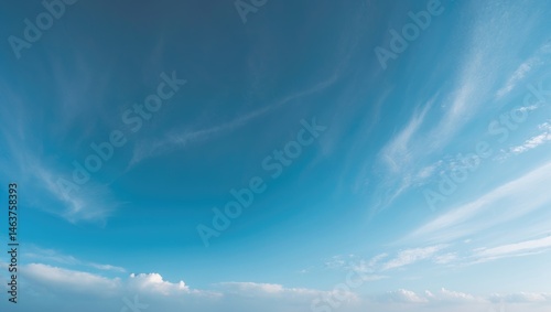 Cloudy sky featuring white clouds against a blue backdrop