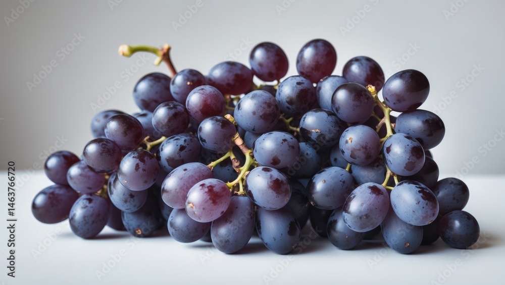 Fototapeta premium Close-up of Juicy Ripe Black Seedless Grapes with White Background